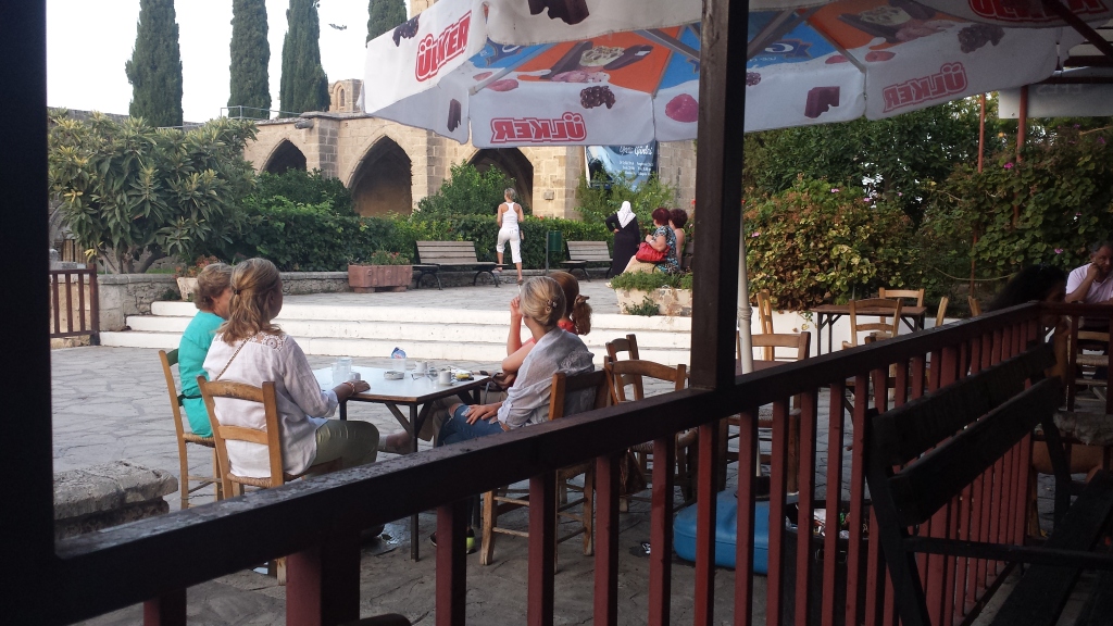 Tourists enjoying refreshments at the Dut ağacı kahvehanesi,  Bellapais